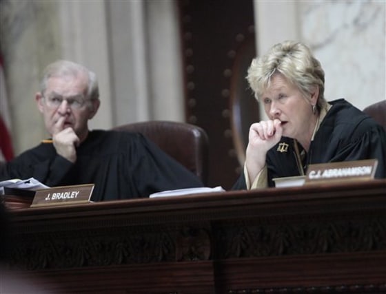 Wisconsin Supreme Court Justices David T. Prosser, Jr., and Ann Walsh Bradley consider oral arguments during a hearing regarding the state's budget bill at the Wisconsin State Capitol, on Monday, June 6. According to a report by Wisconsin Public Radio and the Wisconsin Center for Investigative Journalism, Prosser allegedly grabbed Bradley by the neck with both hands during an argument in Walsh's chambers prior to the court's decision to uphold the bill.